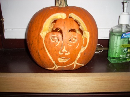 We had an assignment to do a self-portrait on a different unconventional surface each week. Our student center had a Jack-o'-lantern-carving party and I had an idea. 